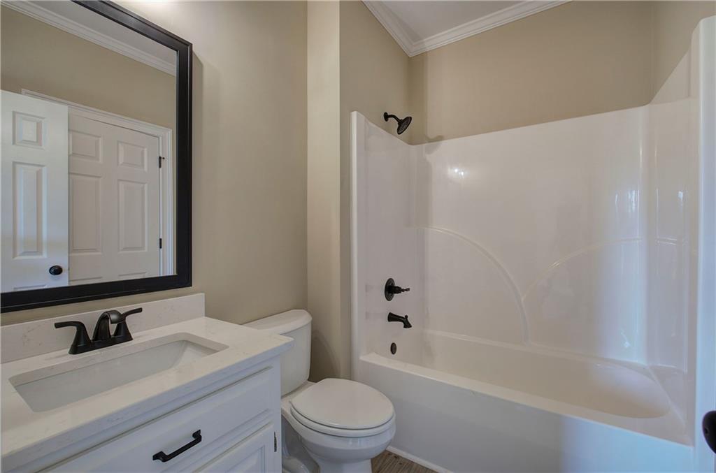 264 Boone Ford Road Southeast Calhoun, GA 30701 - Photo 37 of 66 a bathroom with a sink a toilet and a mirror