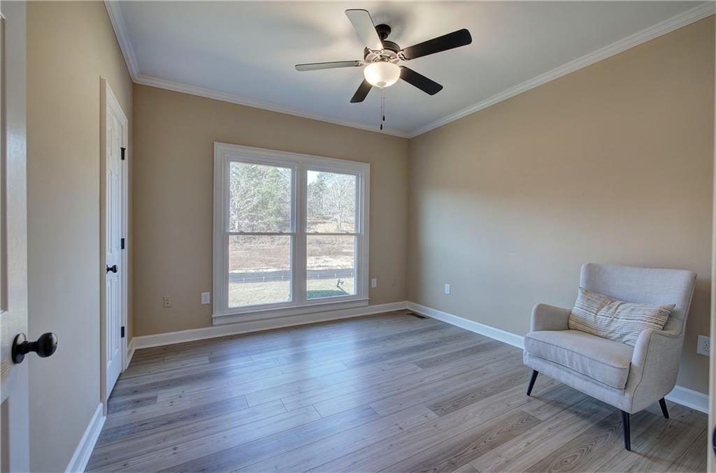 264 Boone Ford Road Southeast Calhoun, GA 30701 - Photo 38 of 66 a view of an empty room with a window and wooden floor