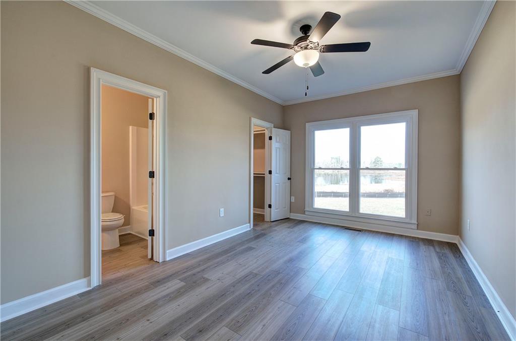 264 Boone Ford Road Southeast Calhoun, GA 30701 - Photo 41 of 66 a view of wooden floor and a chandelier fan in a room