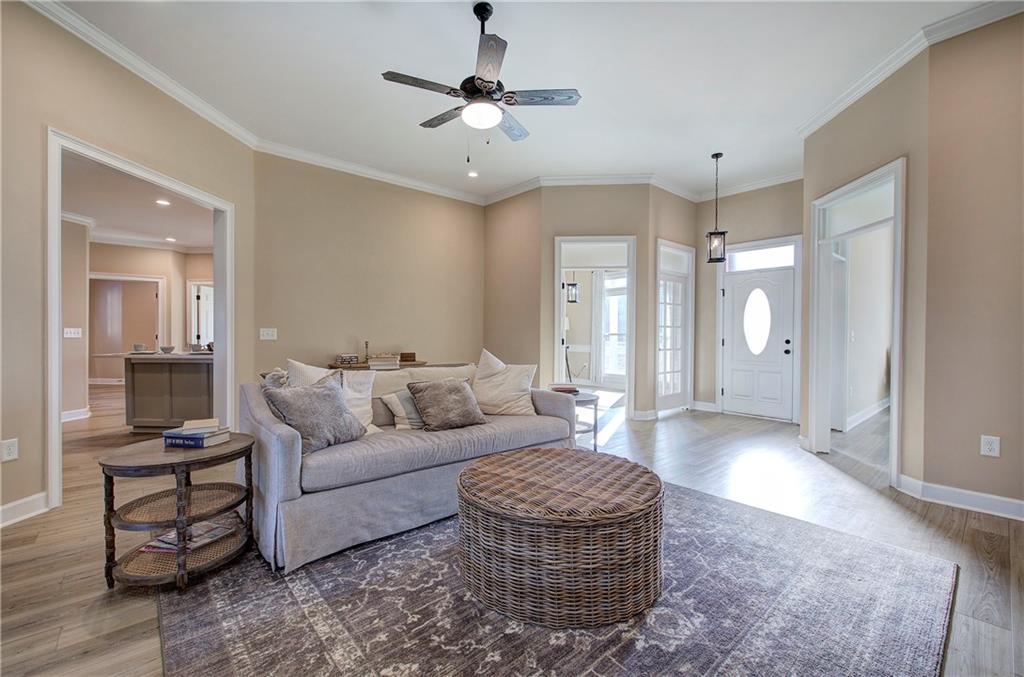 264 Boone Ford Road Southeast Calhoun, GA 30701 - Photo 7 of 66 a living room with furniture a large window and a chandelier
