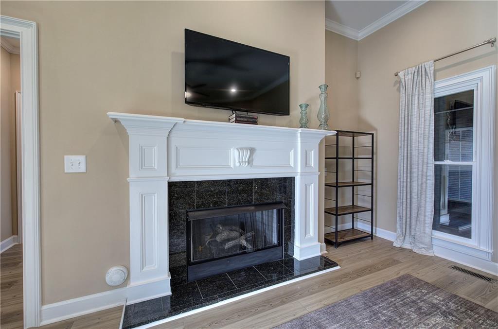 264 Boone Ford Road Southeast Calhoun, GA 30701 - Photo 9 of 66 a living room with a fireplace and a flat screen tv