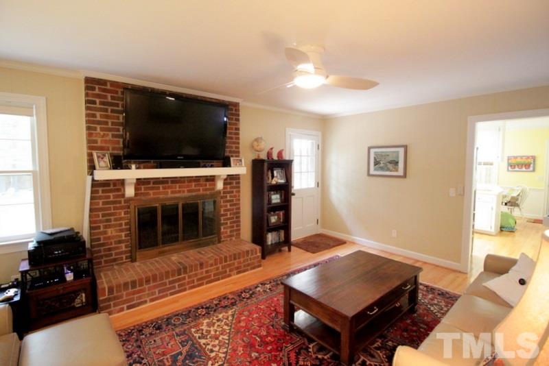 6921 Electra Drive Raleigh, NC 27607 - Photo 11 of 22 a living room with furniture fireplace and flat screen tv