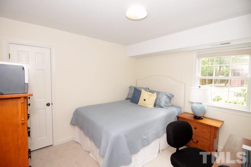 6921 Electra Drive Raleigh, NC 27607 - Photo 12 of 22 a bedroom with a bed and a window