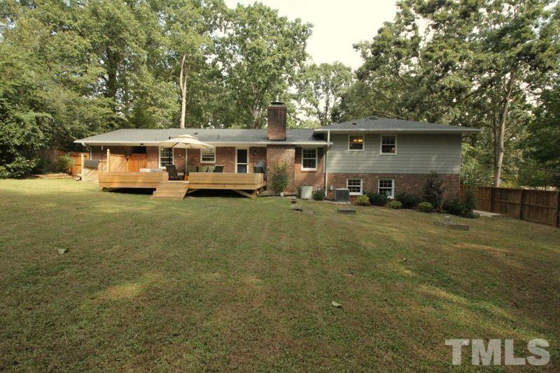 6921 Electra Drive Raleigh, NC 27607 - Photo 22 of 22 a front view of a house with a yard and trees