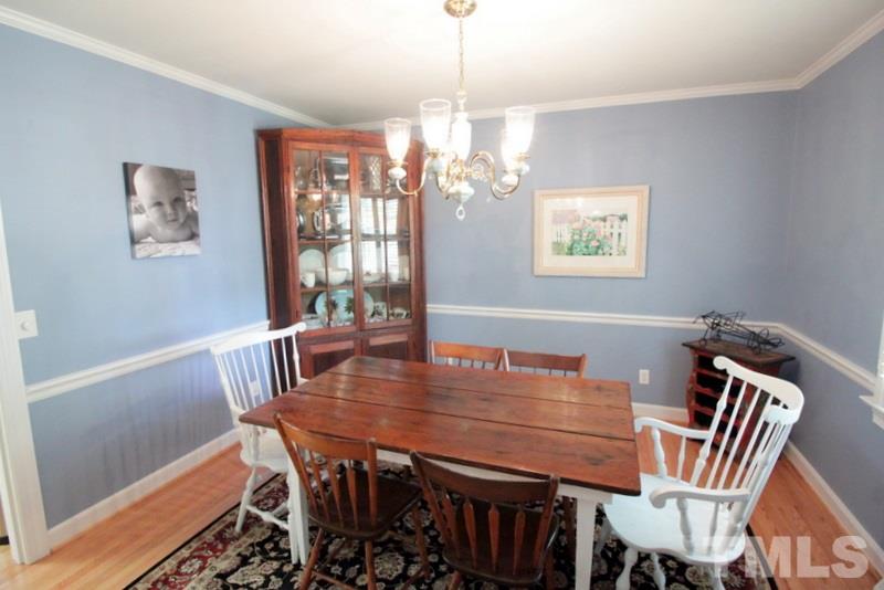 6921 Electra Drive Raleigh, NC 27607 - Photo 6 of 22 a view of a dining room with furniture wooden floor and a chandelier