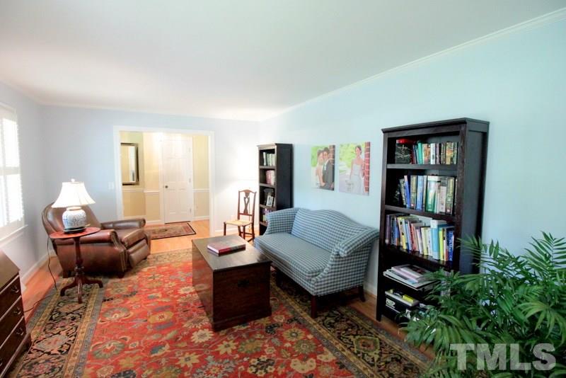 6921 Electra Drive Raleigh, NC 27607 - Photo 7 of 22 a living room with furniture and a bookshelf with wooden floor