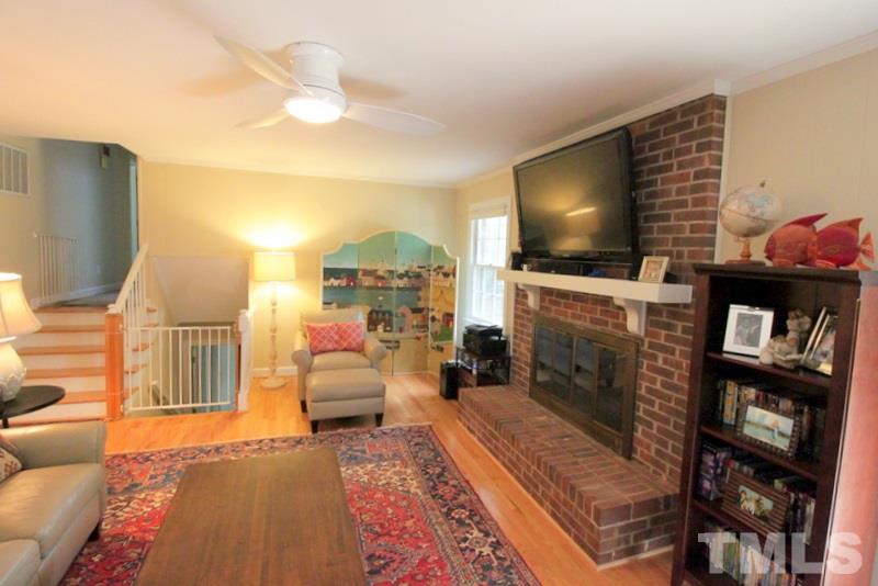 6921 Electra Drive Raleigh, NC 27607 - Photo 9 of 22 a living room with furniture and a flat screen tv