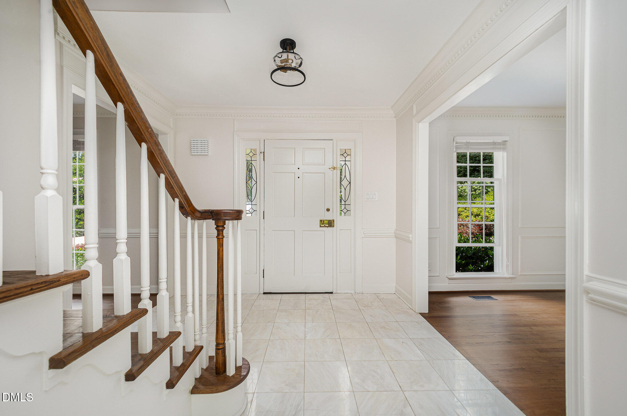 1820 Hunting Ridge Road Raleigh, NC 27615 - Photo 5 of 45 a view of a hallway with wooden floor and staircase