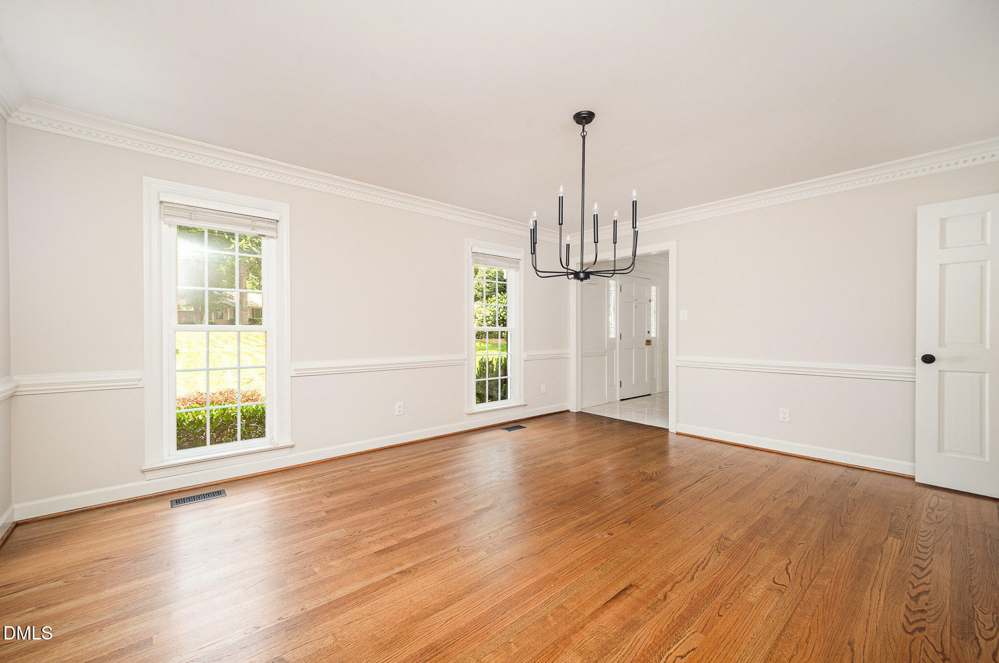 1820 Hunting Ridge Road Raleigh, NC 27615 - Photo 6 of 45 wooden floor in an empty room with a window