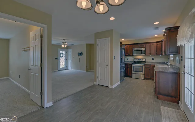 a kitchen with stainless steel appliances granite countertop a refrigerator and a stove top oven