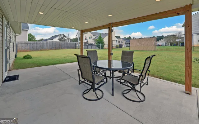 a view of a porch with furniture and garden