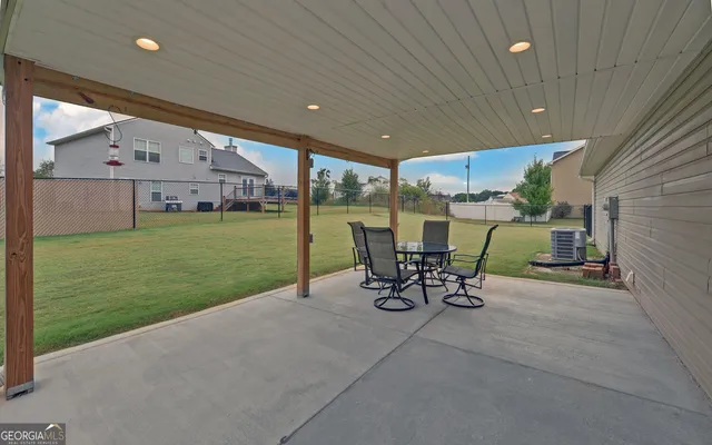 a view of a patio with a table and chairs