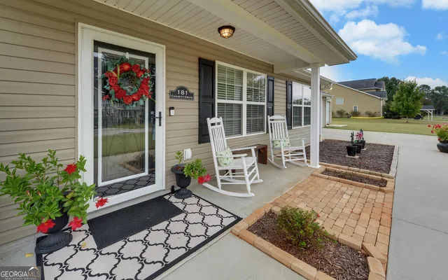 a front view of a house with outdoor seating