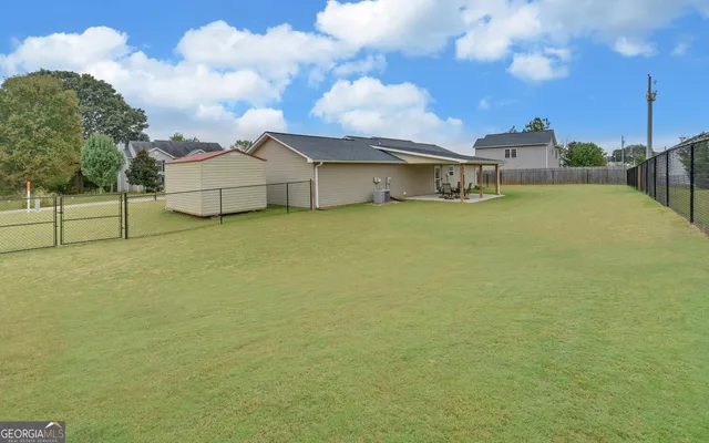 a view of a house with a yard and garage