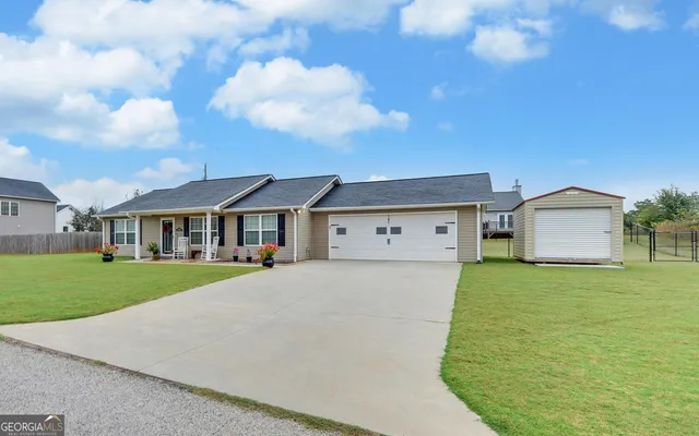 a view of a house with a big yard and a fountain