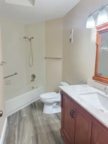 a bathroom with a bath tub with a shower
