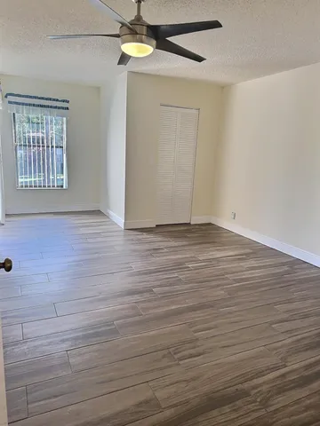 a bathroom with a granite countertop sink a toilet a mirror and shower