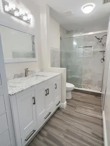 a bathroom with a sink vanity and mirror
