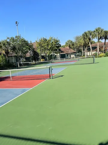 a view of a house with a yard and potted plants
