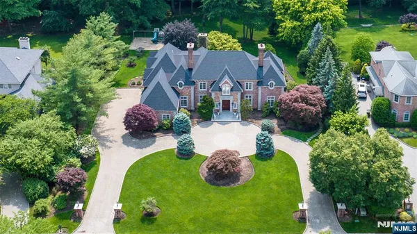 a front view of a house with a yard and potted plants