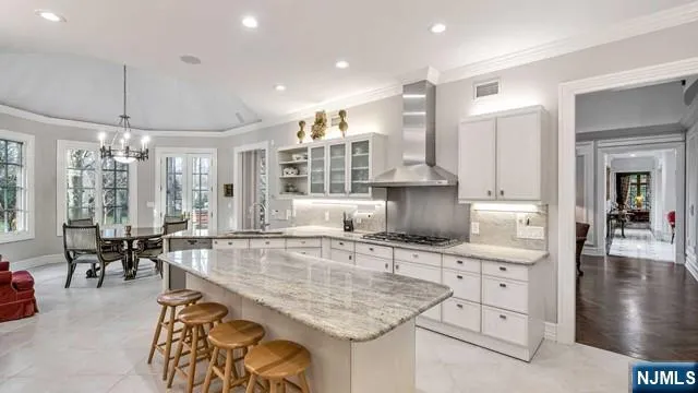a kitchen with stainless steel appliances granite countertop a sink and a counter space