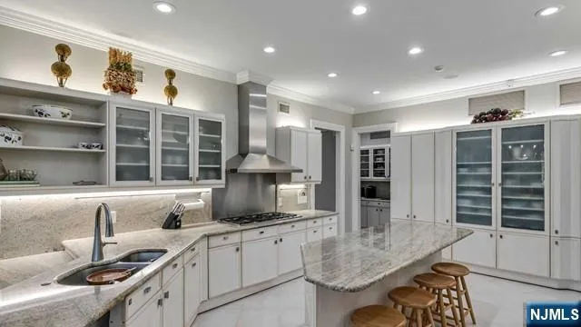 a kitchen with stainless steel appliances granite countertop a sink and a stove
