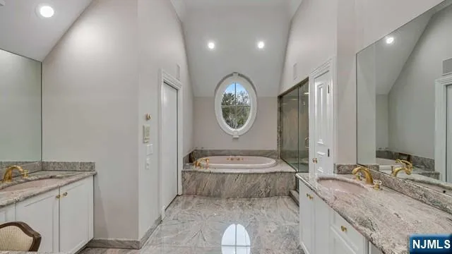 a bathroom with a granite countertop sink mirror vanity and a toilet