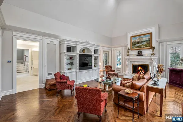 a living room with furniture a fireplace and a flat screen tv