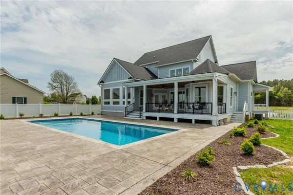 an outdoor space with swimming pool and furniture