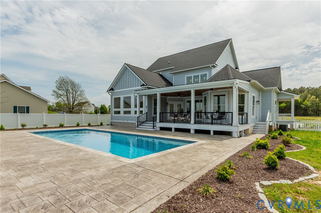 an outdoor space with swimming pool and furniture