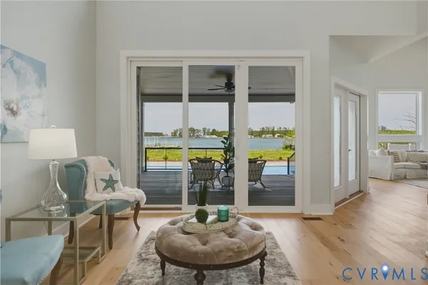 a living room with wooden floor and a potted plant