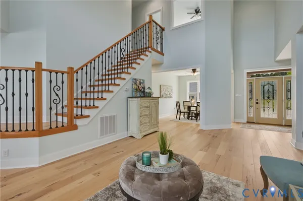 a living room with fireplace furniture and a large window