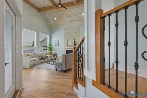 a living room with furniture large window and a fireplace