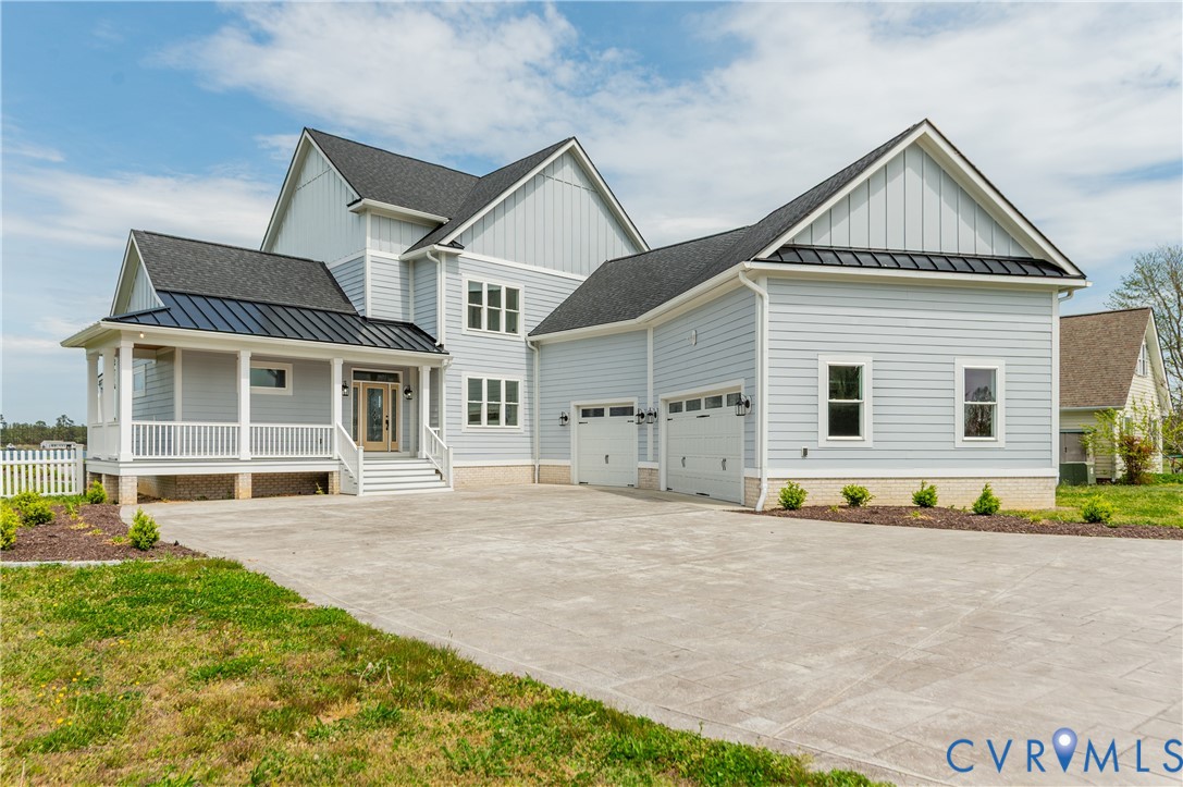 1355 Cowart Road Lottsburg, VA 22511 - Photo 2 of 65 a front view of a house with a yard and garage