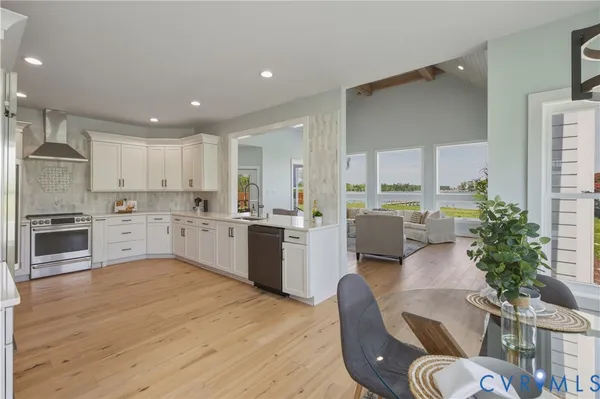 a dining room with wooden floor and a floor to ceiling window