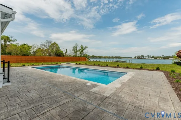 a view of swimming pool with lounge chair in front of house