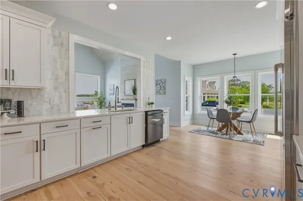 a spacious bedroom with a bed a table and chair