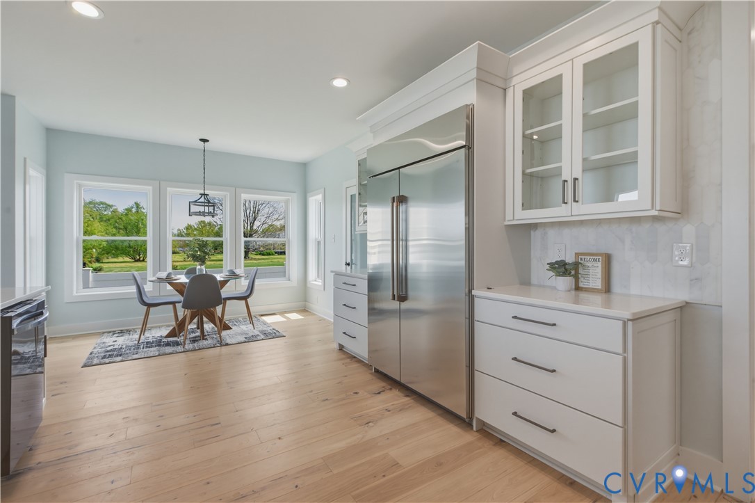 1355 Cowart Road Lottsburg, VA 22511 - Photo 33 of 65 a dining room with wooden floor and a floor to ceiling window