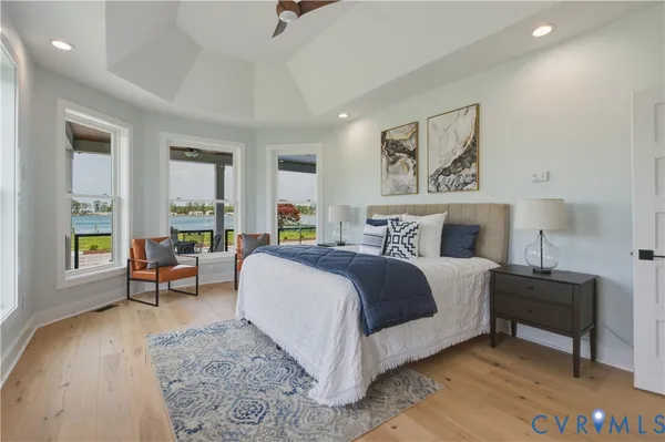 a spacious bathroom with double vanity a mirror and shower