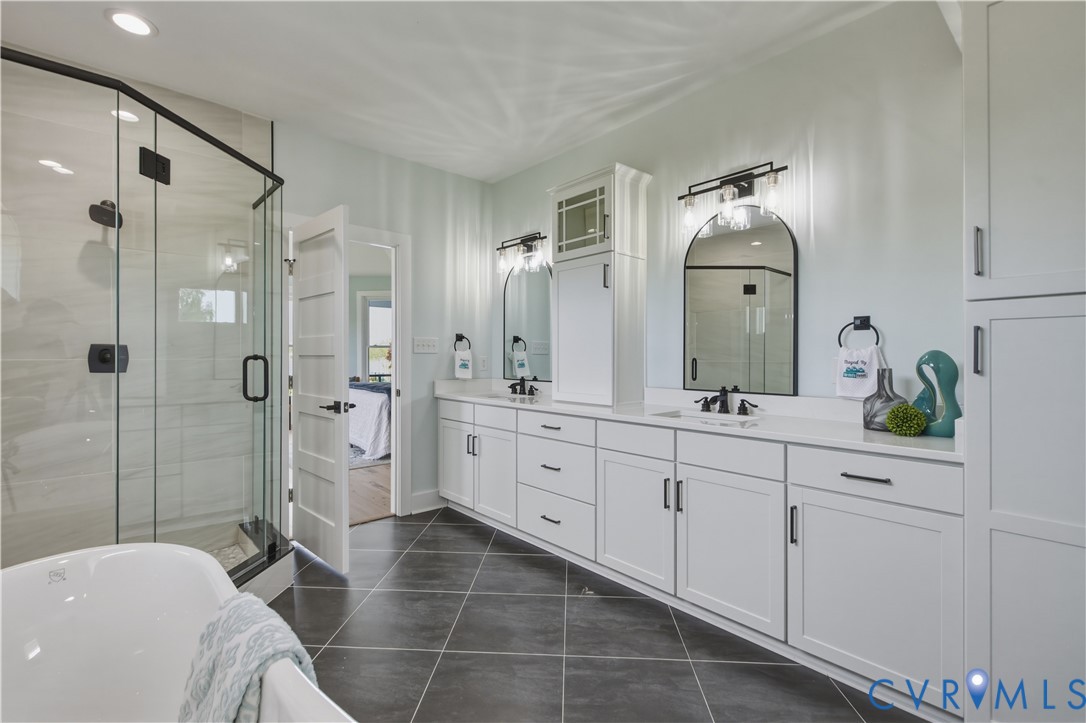 1355 Cowart Road Lottsburg, VA 22511 - Photo 43 of 65 a spacious bathroom with double vanity a mirror and shower