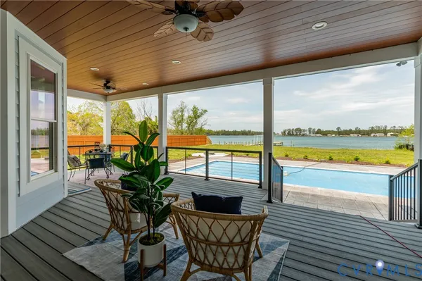 a view of a house with swimming pool and sitting area