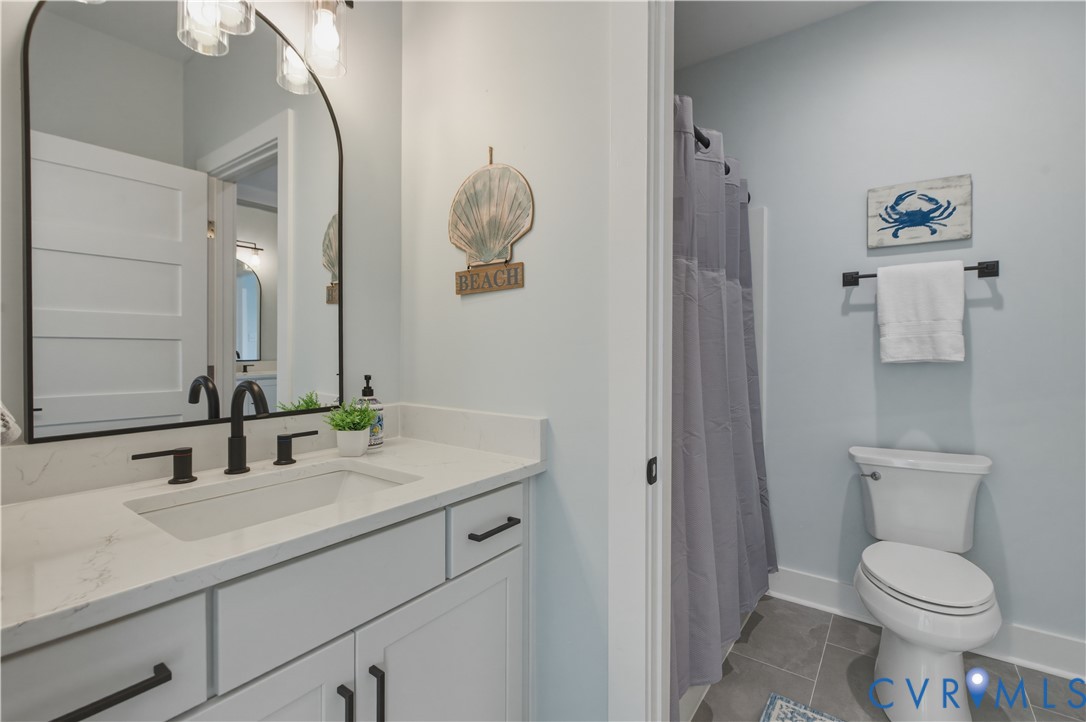 1355 Cowart Road Lottsburg, VA 22511 - Photo 51 of 65 a bathroom with a toilet sink and mirror