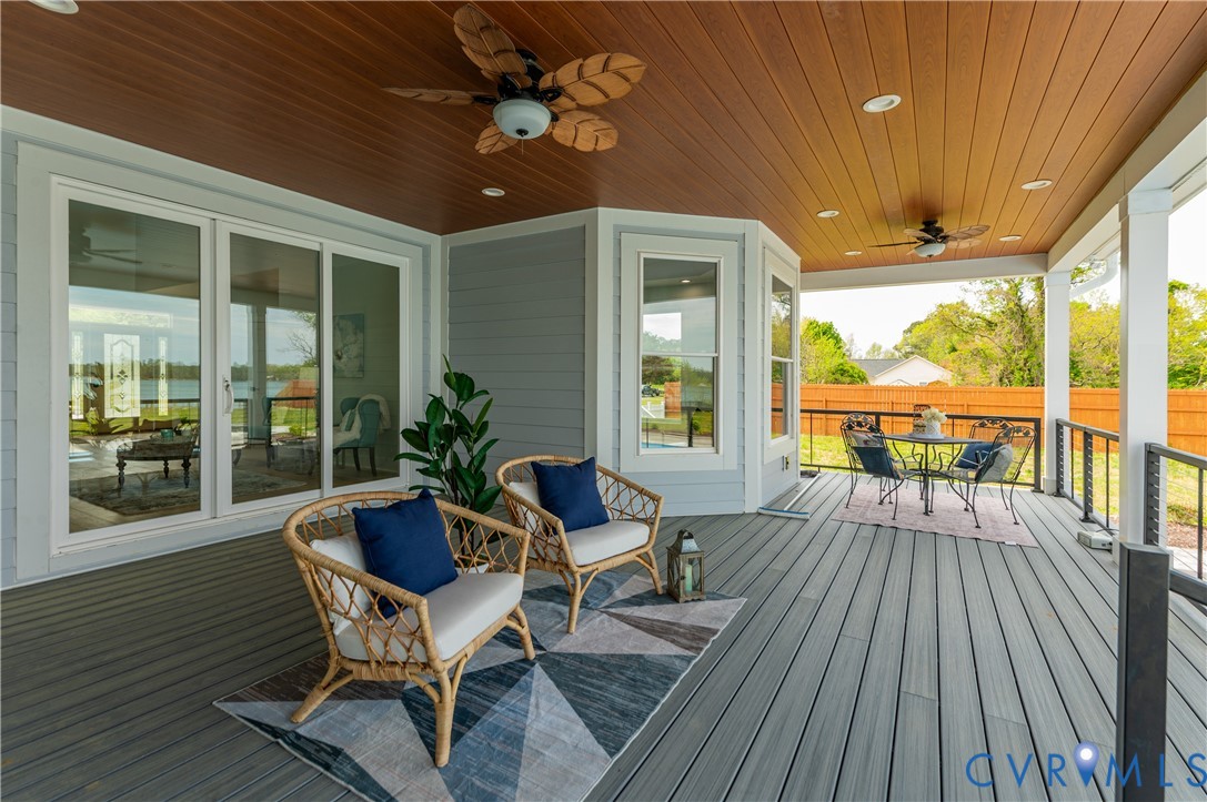 1355 Cowart Road Lottsburg, VA 22511 - Photo 54 of 65 a view of a patio with table and chairs and wooden floor