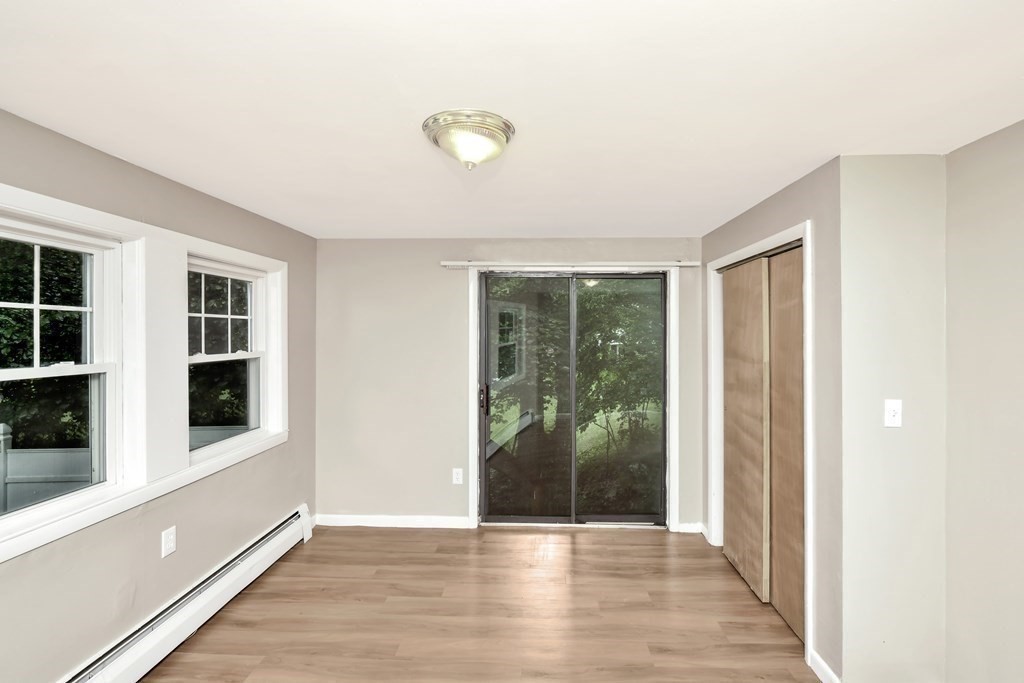 106 Haynes Road Stoughton, MA 02072 - Photo 11 of 34 a view of an empty room with wooden floor and windows