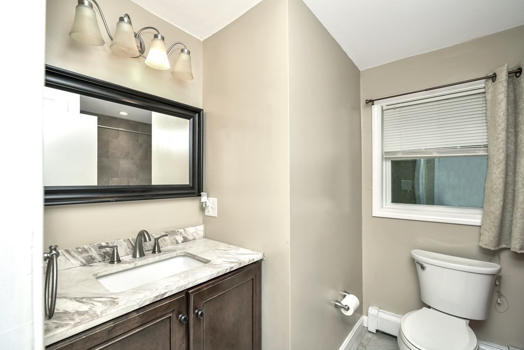 106 Haynes Road Stoughton, MA 02072 - Photo 14 of 34 a bathroom with a granite countertop sink mirror and toilet
