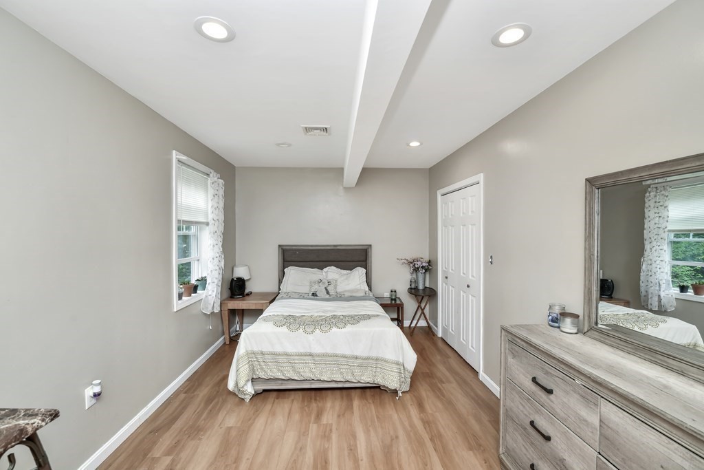 106 Haynes Road Stoughton, MA 02072 - Photo 15 of 34 a bedroom with a large bed and a large window
