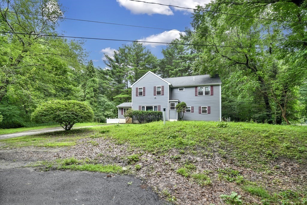106 Haynes Road Stoughton, MA 02072 - Photo 31 of 34 a front view of a house with a yard and garage