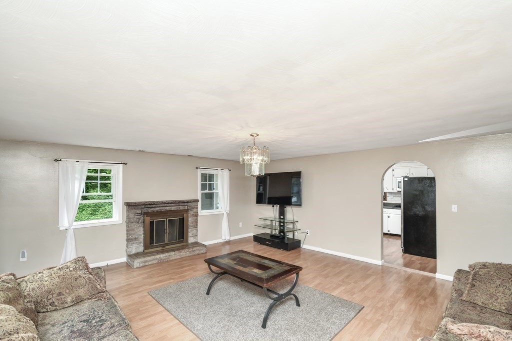 106 Haynes Road Stoughton, MA 02072 - Photo 9 of 34 a living room with furniture and a fireplace
