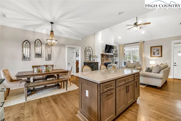 a living room with furniture a chandelier and a dining table