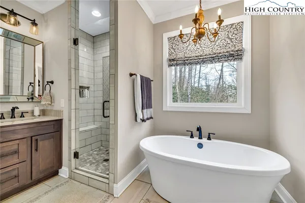 a white bath tub sitting next to a bathroom sink